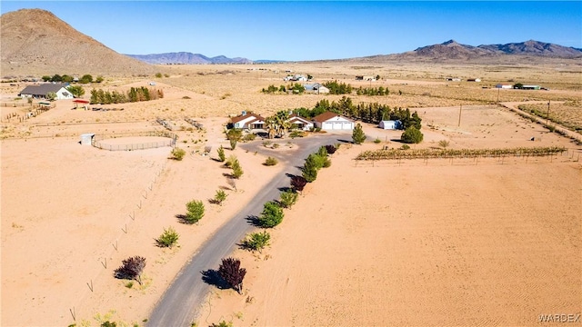 birds eye view of property with view of desert, a rural view, and a mountain view