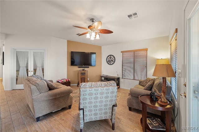 living area featuring french doors, visible vents, ceiling fan, light wood-type flooring, and baseboards