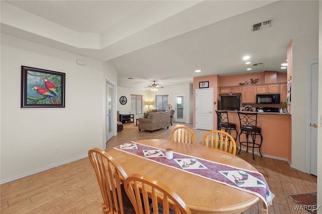 dining room with light wood-style flooring, recessed lighting, a ceiling fan, visible vents, and baseboards