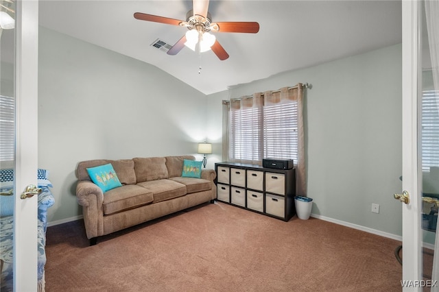 living room featuring carpet floors, lofted ceiling, visible vents, a ceiling fan, and baseboards