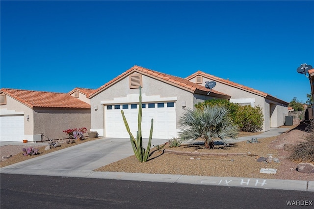 view of front facade with stucco siding, a garage, cooling unit, driveway, and a tiled roof