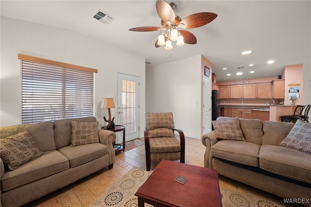 living area featuring ceiling fan, light wood finished floors, visible vents, and recessed lighting