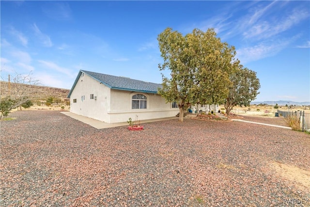 view of front of home with a mountain view and stucco siding