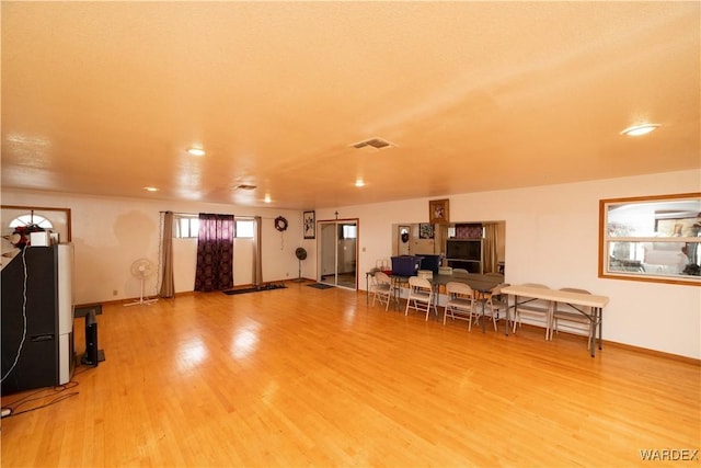 miscellaneous room featuring visible vents, baseboards, and wood finished floors