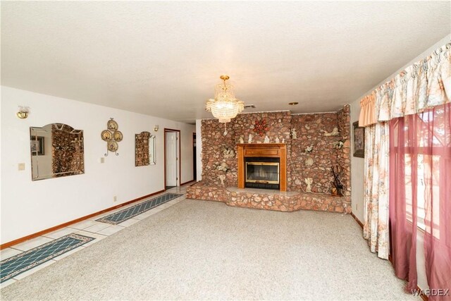 unfurnished living room with carpet, a brick fireplace, a notable chandelier, and a textured ceiling