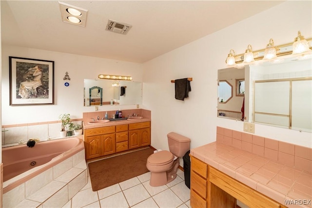 bathroom with double vanity, visible vents, tile patterned floors, a jetted tub, and a sink