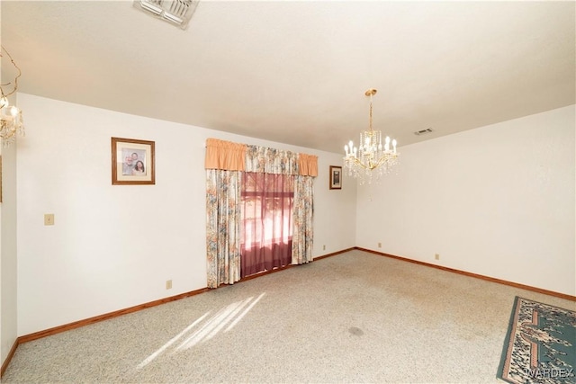 carpeted empty room with baseboards, visible vents, and an inviting chandelier