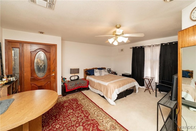 carpeted bedroom featuring visible vents and ceiling fan