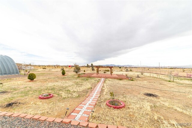 view of yard with a rural view and fence