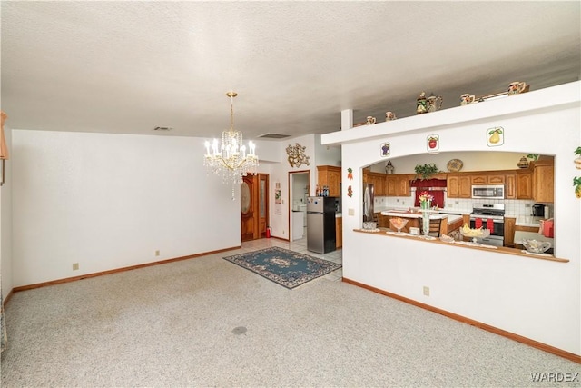 interior space with light carpet, an inviting chandelier, and baseboards