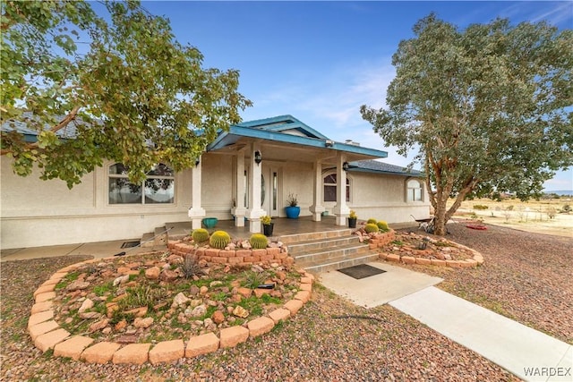 view of front of house featuring a porch and stucco siding