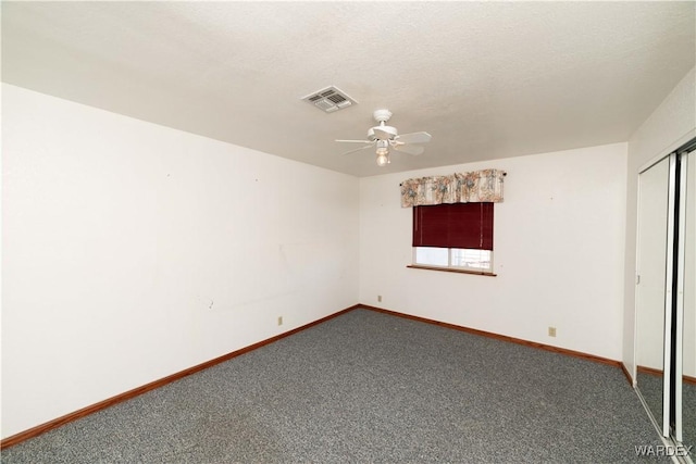 unfurnished bedroom with ceiling fan, carpet floors, visible vents, baseboards, and a closet