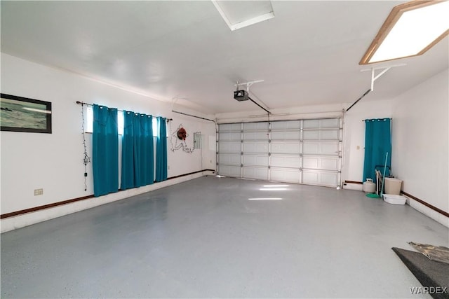 garage with baseboards and a garage door opener