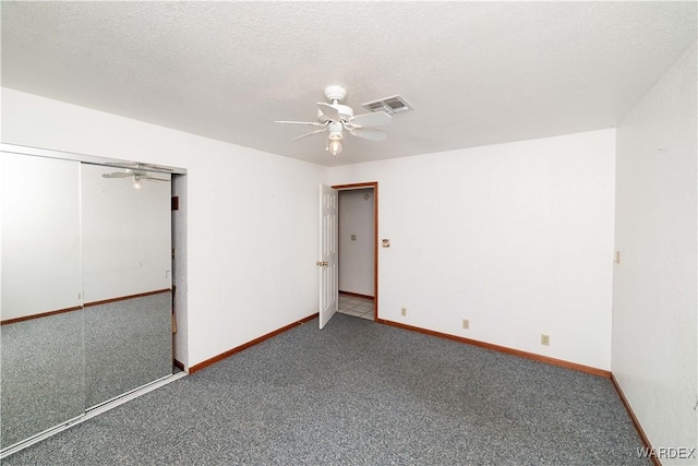 unfurnished bedroom featuring visible vents, carpet flooring, ceiling fan, a textured ceiling, and baseboards