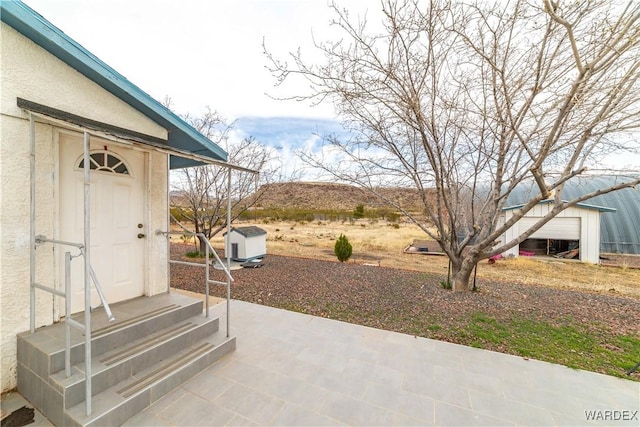 view of patio / terrace featuring entry steps and a storage shed