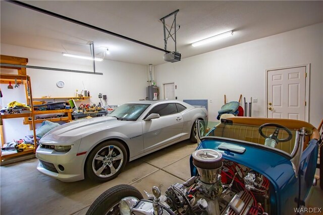 garage with a garage door opener and electric water heater