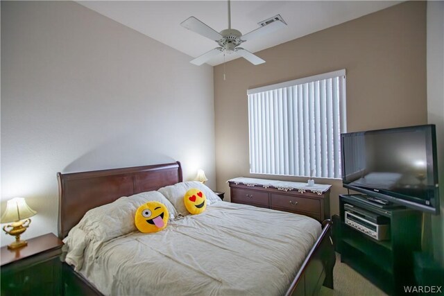 carpeted bedroom with ceiling fan and visible vents