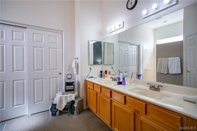 bathroom featuring a sink and double vanity