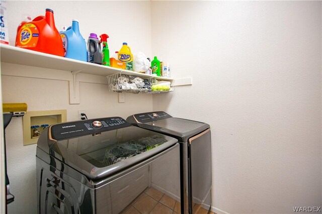 washroom featuring laundry area, tile patterned flooring, and separate washer and dryer