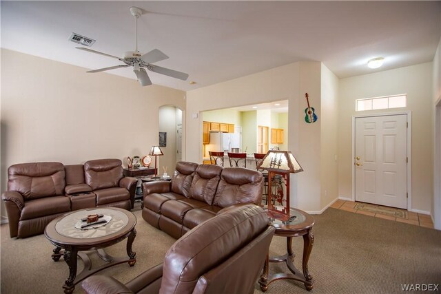 living area featuring light carpet, ceiling fan, visible vents, and baseboards