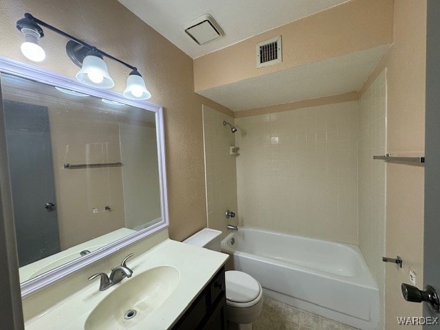 bathroom featuring toilet, a textured wall, shower / washtub combination, and visible vents