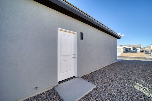 property entrance with stucco siding