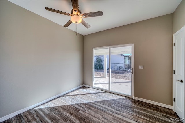 empty room featuring ceiling fan, dark wood finished floors, and baseboards