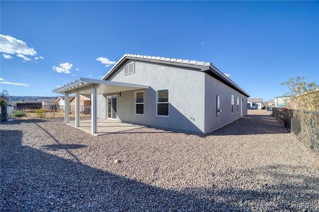 back of house featuring a patio area, a fenced backyard, and stucco siding