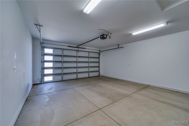 garage featuring baseboards and a garage door opener