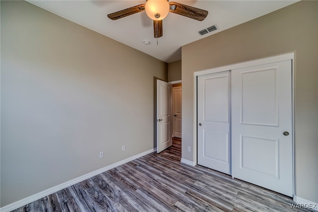 unfurnished bedroom with a closet, visible vents, ceiling fan, light wood-type flooring, and baseboards