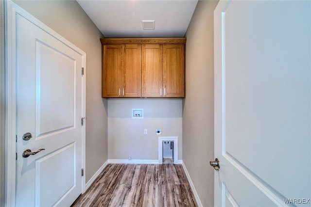 clothes washing area featuring washer hookup, visible vents, baseboards, cabinet space, and electric dryer hookup