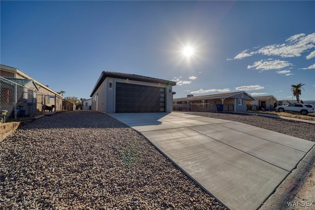 view of front of house featuring driveway, a residential view, and fence