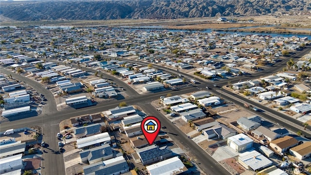 drone / aerial view featuring a residential view and a mountain view