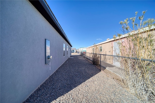 exterior space with fence and stucco siding