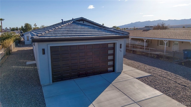 detached garage with fence and a mountain view