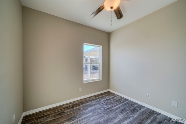 empty room with dark wood-style floors, baseboards, and a ceiling fan