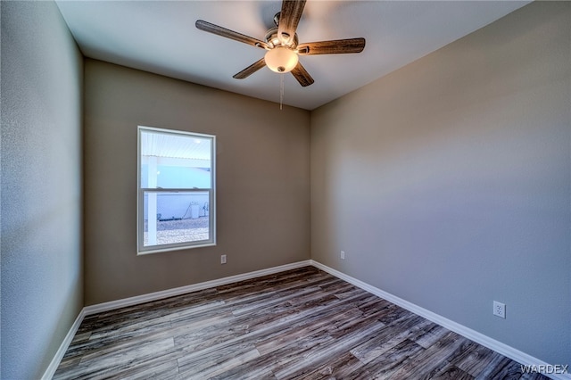 empty room with ceiling fan, baseboards, and wood finished floors