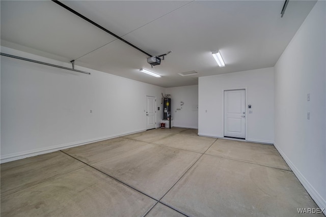 garage featuring a garage door opener, water heater, and baseboards