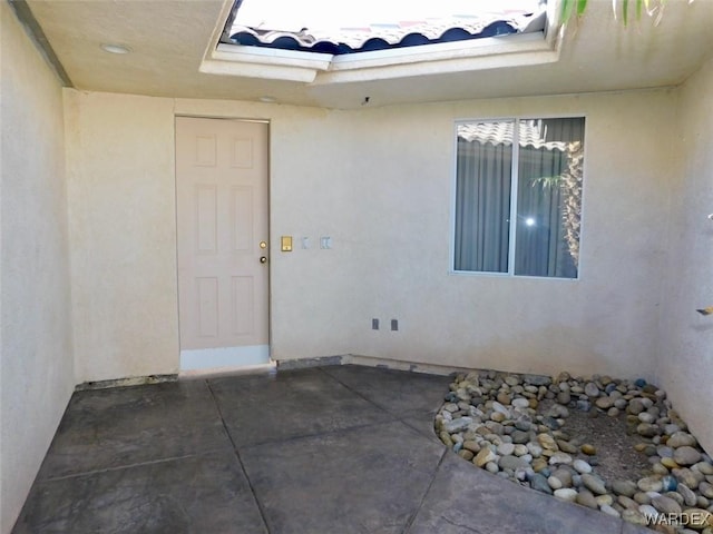 property entrance featuring stucco siding