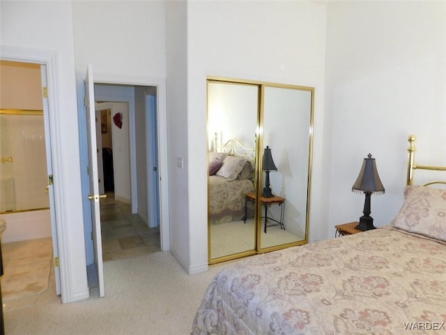 bedroom featuring light carpet and a closet