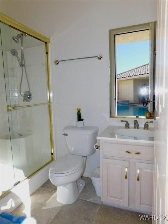 full bath with a stall shower, tile patterned flooring, and vanity