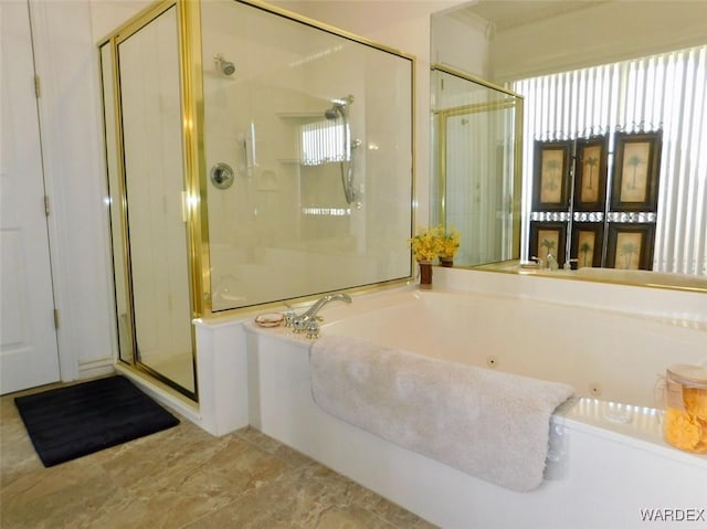 full bathroom with a wealth of natural light, a garden tub, and a shower stall