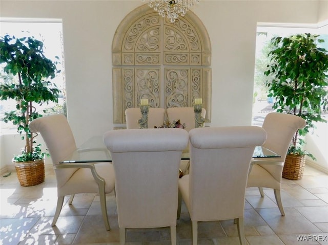 dining room with a wealth of natural light and a notable chandelier