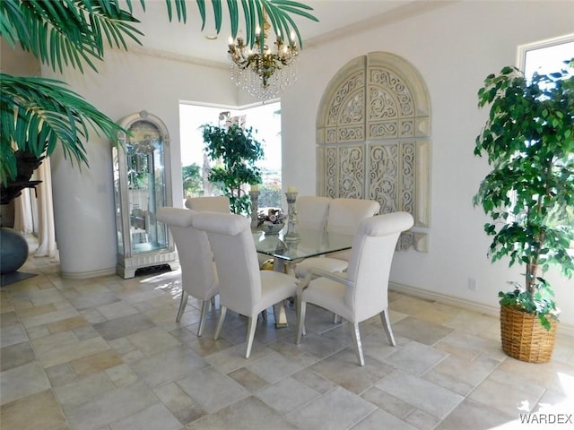 dining room featuring a notable chandelier, baseboards, and a wealth of natural light