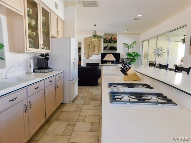 kitchen with ceiling fan, white appliances, visible vents, light countertops, and glass insert cabinets