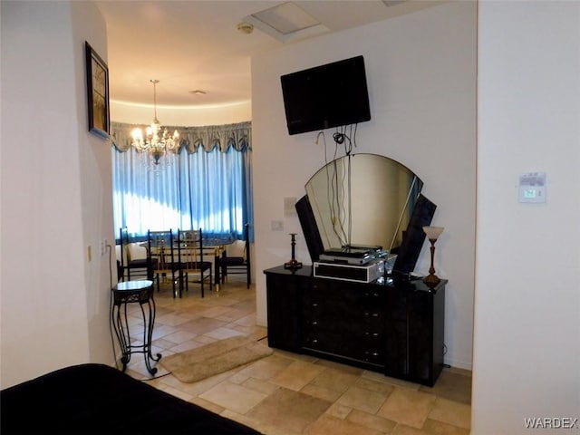 bedroom featuring a notable chandelier