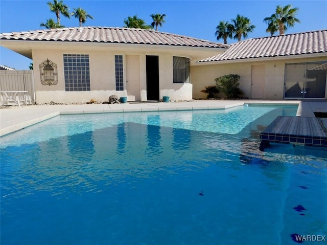 outdoor pool featuring fence