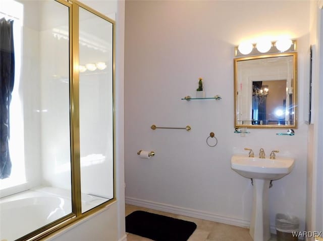 bathroom featuring enclosed tub / shower combo and baseboards