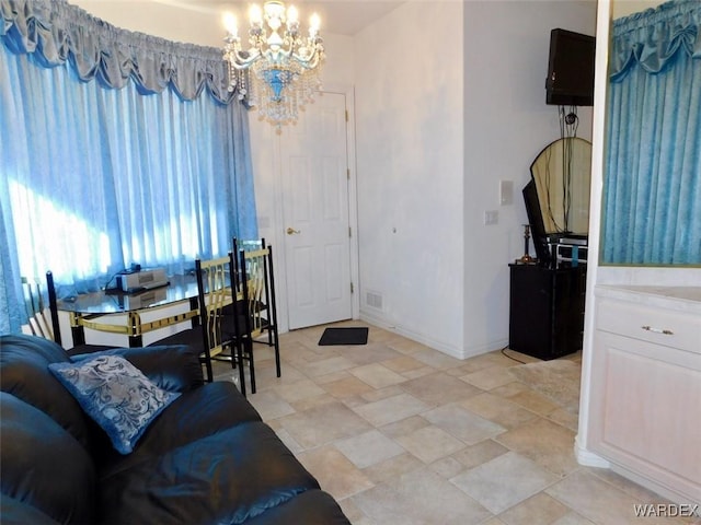 dining room featuring baseboards, visible vents, and an inviting chandelier