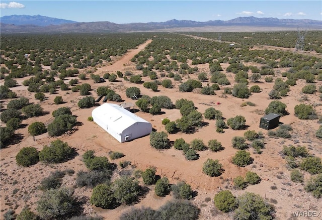 aerial view featuring a mountain view and view of desert